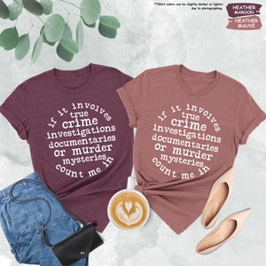 a couple of t - shirts that are on a table