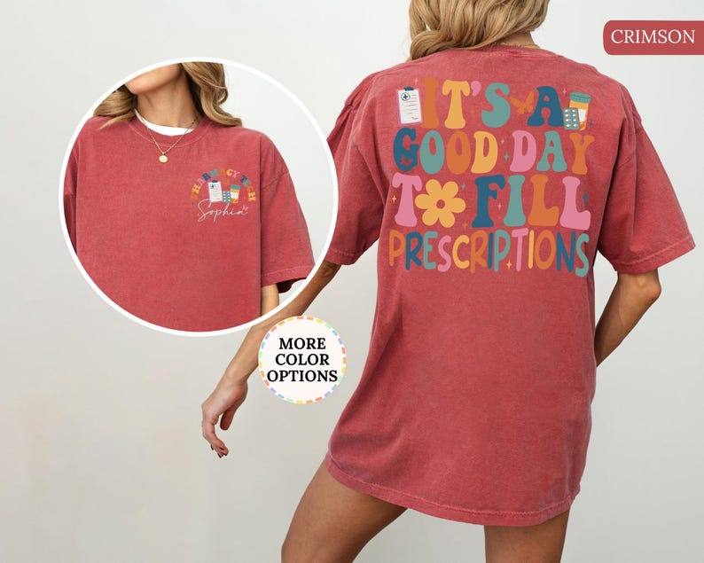 May include: Crimson t-shirt featuring the text "IT'S A GOOD DAY TO FILL PRESCRIPTIONS" in various colours on the back. The front displays a smaller pharmacy-themed graphic with the text "Pharmacy Sophia".