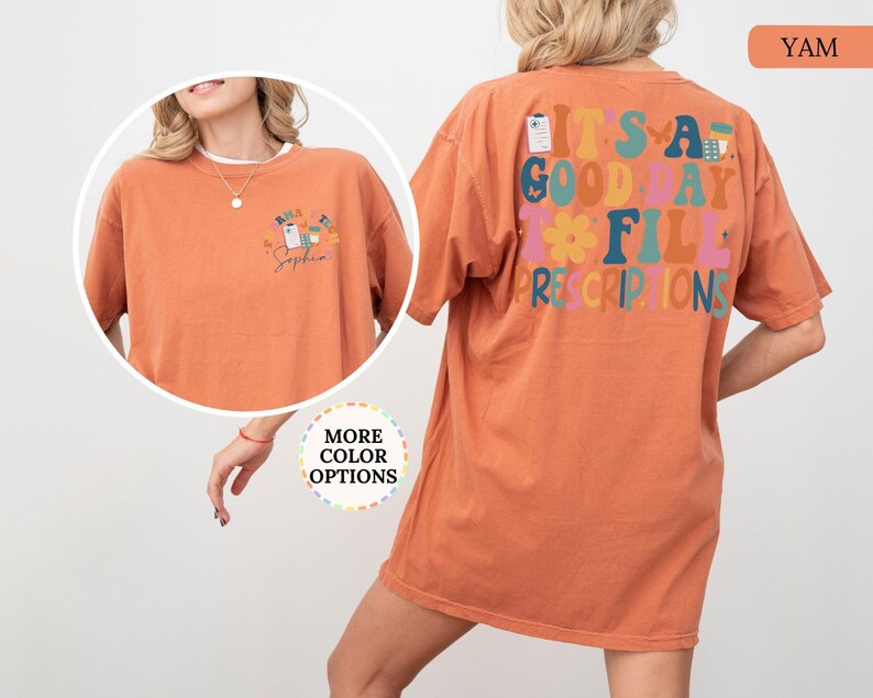 May include: A terracotta-coloured t-shirt featuring the text "IT'S A GOOD DAY TO FILL PRESCRIPTIONS" in various colours on the back. The front has a smaller design with prescription graphics and the name "Sophia".