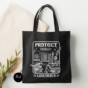 May include: Black tote bag with a white graphic design featuring a stack of books, a quill pen, and the text "Protect Public Libraries".