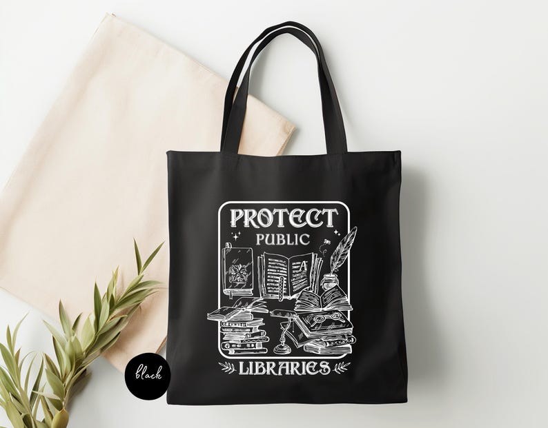 May include: Black tote bag with a white graphic design featuring a stack of books, a quill pen, and the text "Protect Public Libraries".