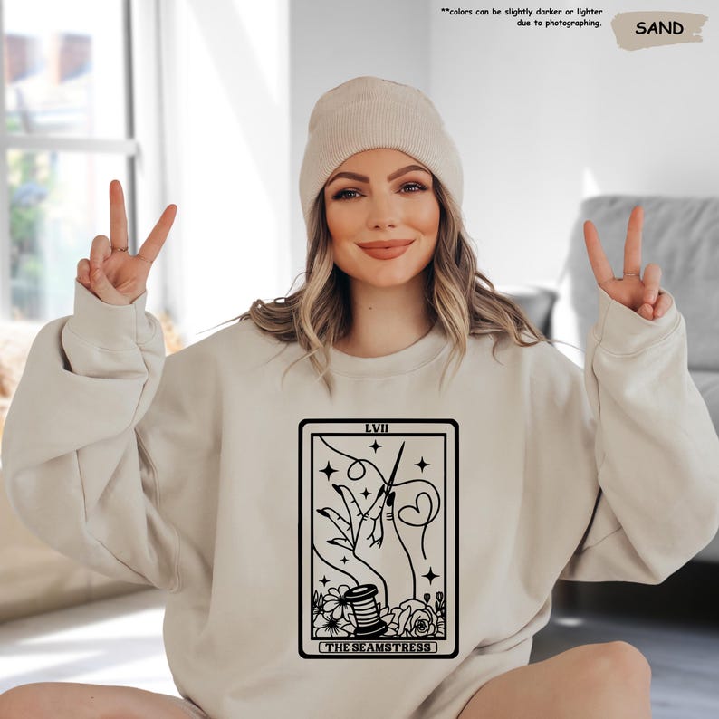 a woman sitting on the floor with her hands up