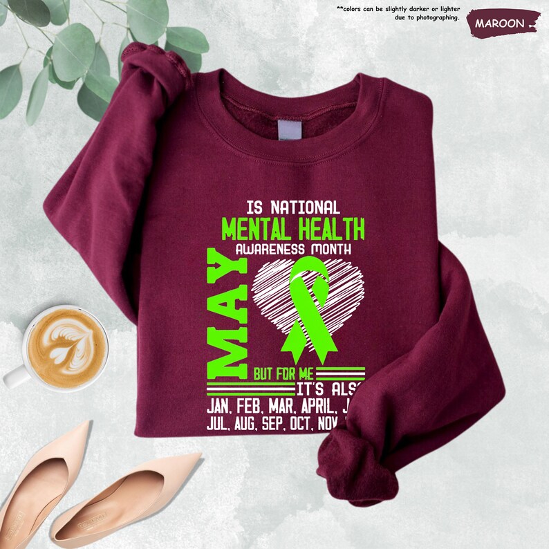 a t - shirt with a green ribbon on it