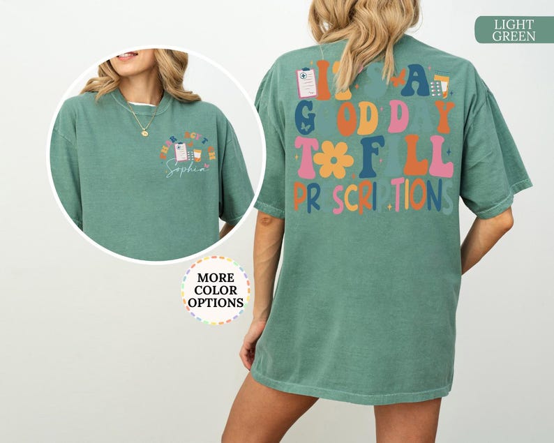 May include: Light green t-shirt featuring the text "It's a Good Day to Fill Prescriptions" in various colours on the back. The front has a smaller design with pharmacy graphics and the name "Sophia".
