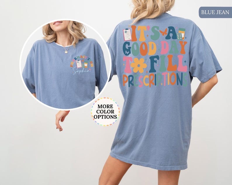 May include: Blue jean coloured t-shirt with the text "It's a good day to fill prescriptions" on the back. The front of the shirt has a smaller design with the text "Pharmacist Sophia". The shirt has short sleeves and a crew neck.