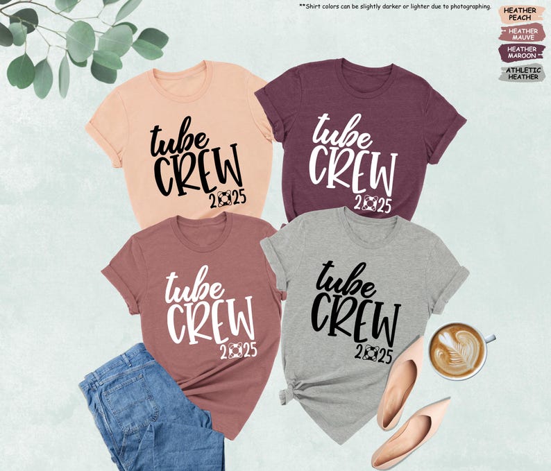 May include: Four t-shirts with the text "tube crew 2025" in black and white. The shirts are in different colors: peach, maroon, heather grey, and athletic heather.
