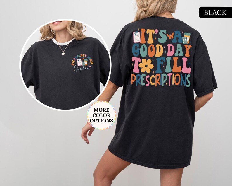 May include: Black t-shirt with the text "IT'S A GOOD DAY TO FILL PRESCRIPTIONS" in colourful, retro-style lettering on the back. The front features a smaller design with "PHARMACY TECH" and a name. A fun, casual tee.
