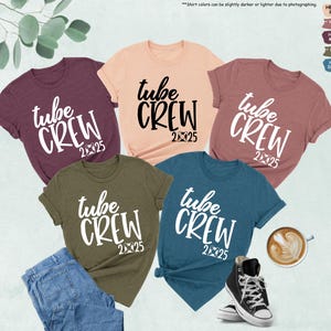 May include: Five t-shirts in different colors with the text "tube crew 2025" printed in white on the front. The shirts are a maroon, peach, pink, olive green, and teal.