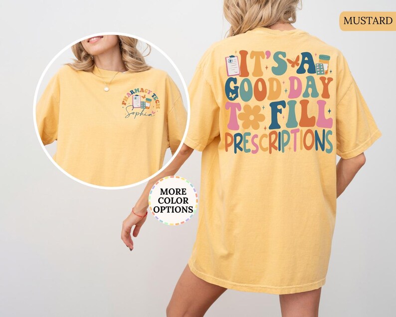 May include: Mustard-coloured t-shirt with the text "IT'S A GOOD DAY TO FILL PRESCRIPTIONS" in colourful, retro-style lettering. The front of the shirt features a pharmacy tech design. The shirt is a comfortable, oversized fit.