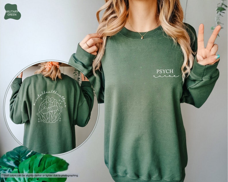 a woman wearing a green sweatshirt with a peace sign on it