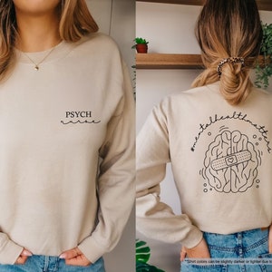 a woman wearing a sweater with a design on it