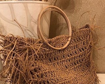Beige hand-knitted hand-knitted bag with paper string and wooden ring hanger