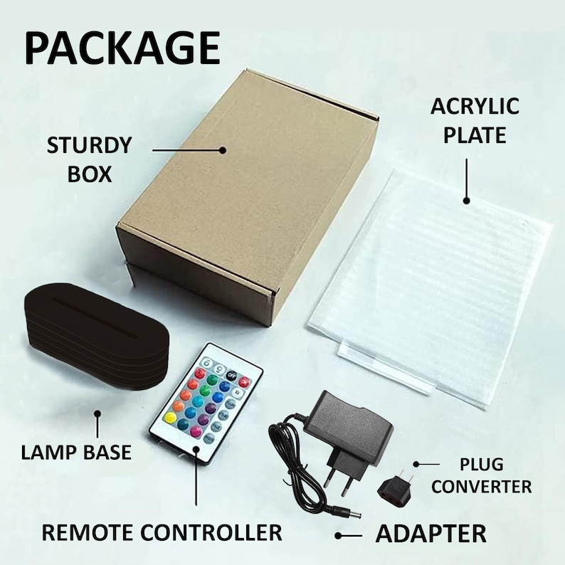 May include: Package contents for a 3D LED night light. The package includes a sturdy box, a clear acrylic plate, a black lamp base, a remote control with colorful buttons, a power adapter, and a plug converter.