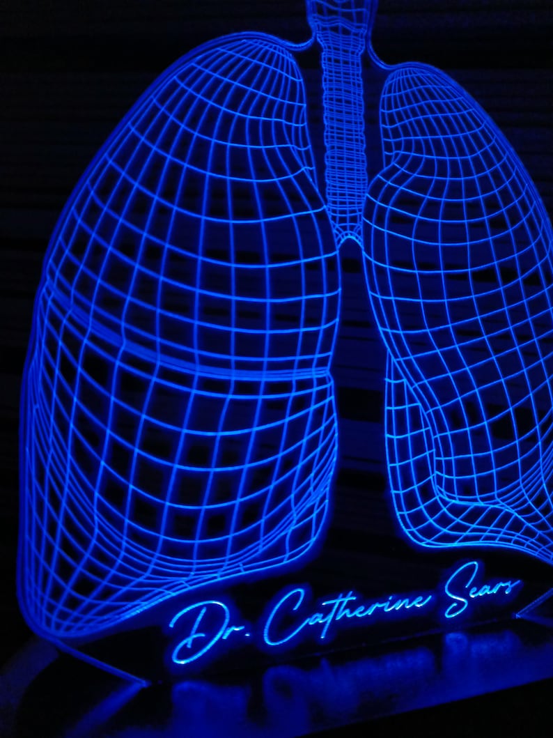 May include: A blue 3D printed light sculpture of a pair of lungs with a wireframe design. The base of the sculpture has the text "Dr. Catherine Sears" in a cursive font.