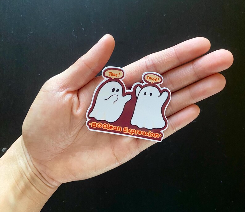 May include: Two white ghost stickers with speech bubbles. The ghost on the left says "True!" and the ghost on the right says "False!" The sticker is on a red background with the text "*BOOlean Expression*" in orange.