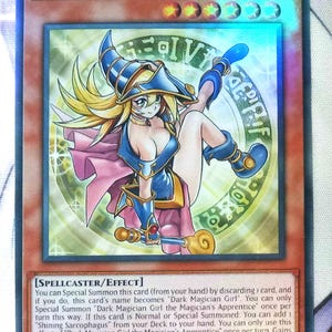 May include: A white ceramic mug with a black handle and the text "But First, Coffee" in a bold, black font. The mug is set against a neutral background, highlighting its simple design.