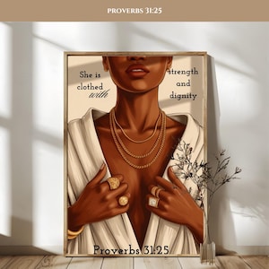 Puede incluir: Una impresión artística enmarcada que presenta a una mujer de piel oscura con joyas de oro y una bata blanca. La obra de arte incluye el texto "She is clothed with strength and dignity" y "Proverbs 31:25". La imagen tiene una paleta de colores neutros.