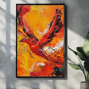 Può includere: Dipinto astratto di un uccello in volo, in vibranti tonalità di rosso, arancione e giallo. L'opera d'arte è incorniciata in un bordo nero, creando un contrasto sorprendente. Le pennellate strutturate aggiungono profondità e movimento.