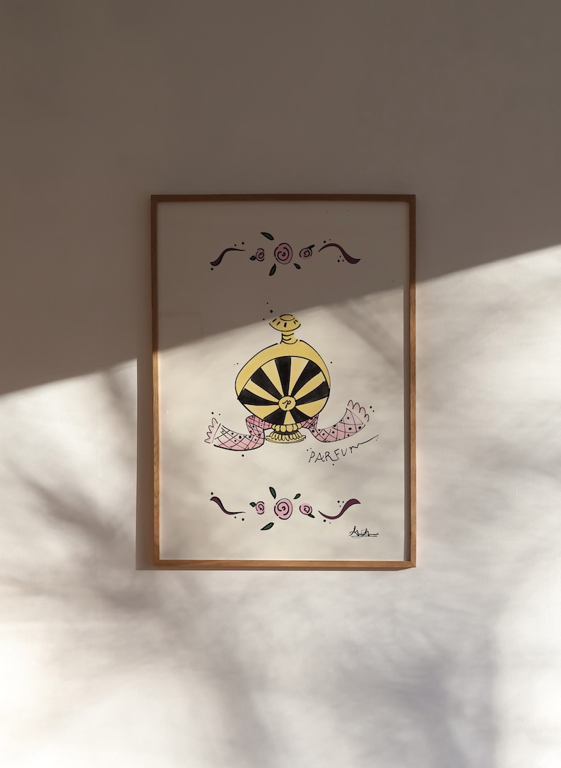 May include: A framed artwork featuring a whimsical perfume bottle design. The bottle is yellow and black, with a pink and white scarf. The word "PARFUM" is written below the bottle. Decorative floral elements and a wooden frame complete the piece.