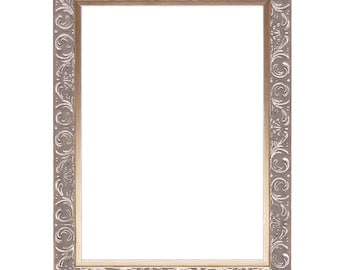 May include: A silver ornate picture frame with a decorative floral design. The frame is made of wood and has a smooth, polished finish.