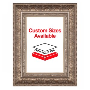 May include: Ornate, rectangular picture frame with a detailed, bronze-colored border. The frame has a white interior with the text "Custom Sizes Available" in red, and a red and black logo that says "Print Frame Box".