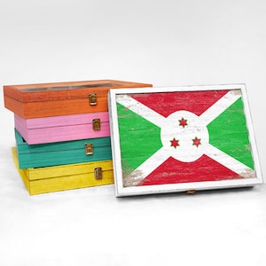 May include: Four colorful wooden boxes with lids stacked on top of each other. The top box has a white frame with a distressed wood print of the flag of Burundi.
