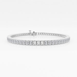 May include: A silver tennis bracelet with a row of emerald-cut diamonds.