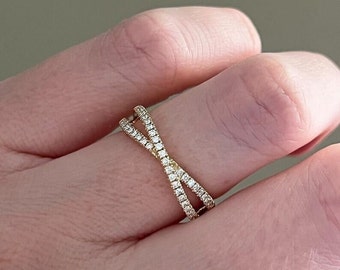 May include: A gold ring with a criss-cross design, set with small diamonds.