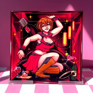 May include: A vibrant illustration of a woman in a red outfit, set against a red backdrop with a microphone and cocktails. The artwork features a dynamic pose, with orange boots and a playful expression. The image is framed in a clear acrylic block.