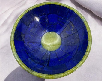 May include: A blue and green stone bowl with a mosaic design. The bowl is made of lapis lazuli and jade.