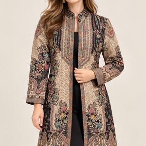 May include: A long-sleeved, knee-length open jacket featuring a complex, multi-colored floral and paisley pattern in shades of black, beige, red, and blue. The garment has a structured mandarin collar and a straight, tailored silhouette.