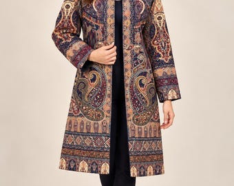 May include: A long-sleeved, knee-length open coat featuring a complex, multi-colored paisley and geometric pattern in shades of navy blue, deep red, gold, and cream. The coat has a structured collar, straight sleeves, and a straight hemline.