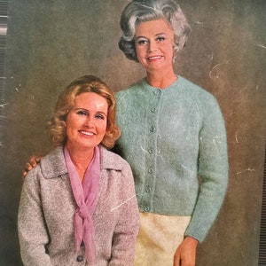 May include: Vintage Patons Classics knitting pattern book cover showing two women in knitted cardigans. The cover text includes: TOTEM, JET, MOHAIR, BLUEBELL, L'AMOUR, PATONYLE, FUZZY WUZZY. The book is for raglan cardigans for ladies, sizes 32 to 42.