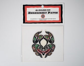 May include: An embroidered patch featuring a black, green, and red stylized creature with a white background. The patch is packaged in a clear plastic bag with a red and black header card that reads "Golden Top Embroidery Patch".