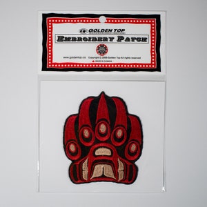 May include: Red and black embroidered patch of a bear paw with the text "Golden Top Embroidery Patch" on a white card.