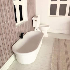 May include: A white bathtub with a black faucet in a dollhouse bathroom. The bathroom has white tile floors and a white toilet.