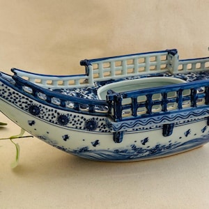 May include: A set of three ceramic mugs with a speckled, matte finish. Each mug features a different color: light blue, cream, and gray. The mugs have a simple, modern design and a comfortable handle.