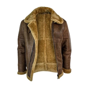 May include: A brown leather jacket with a shearling lining and collar. The jacket has a zipper closure and a classic aviator style. The interior lining is a lighter shade of brown, providing a warm and comfortable look.