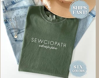May include: Green t-shirt with the text "SEWCIOPATH will cut for fabric" in white lettering.