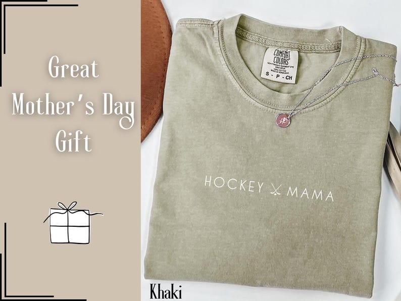 May include: Khaki green t-shirt with the text "HOCKEY MAMA" and a small pink tag with the text "COMFORT COLORS" on the front.
