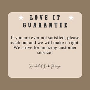 May include: A tan-colored graphic with the text "LOVE IT GUARANTEE" and a message about customer satisfaction. The text also includes "Xo. Ash N Dak Design". Two white star graphics are on the top corners.