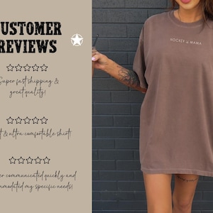May include: A brown oversized t-shirt with the text "HOCKEY & MAMA" printed on the front. The shirt is being modeled by a person. The background is a brick wall.