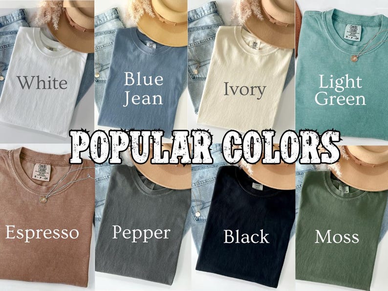 May include: A collection of eight t-shirts in various colors, including white, blue jean, ivory, light green, espresso, pepper, black, and moss. Each shirt is folded and displayed with a hat and denim jeans. The text "POPULAR COLORS" is overlaid.