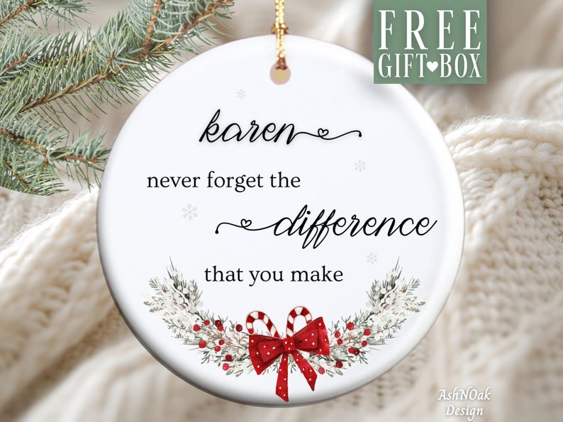 May include: A white ceramic Christmas ornament with the text "Karen never forget the difference that you make." The ornament features a festive design with a red bow, candy canes, and greenery. A gold string is attached for hanging.