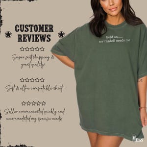 May include: A moss green t-shirt with the text "hold on..... my ragdoll needs me" in white. The shirt is part of a customer reviews graphic with text about shipping and quality.