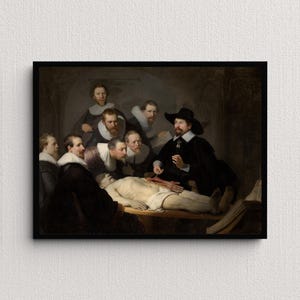 May include: A framed print of Rembrandt's "The Anatomy Lesson of Dr. Nicolaes Tulp." The painting depicts a group of men observing a dissection. The central figure, in a black hat, is performing the dissection. The scene is set in a dimly lit room.