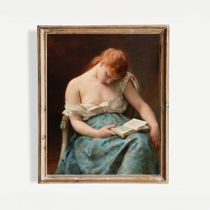 May include: A framed vintage painting shows a woman with red hair, reading a book while seated. She is dressed in a white top and a blue patterned skirt. The artwork is in a wooden frame, presenting a classic style.