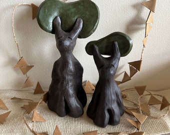 Cute pair of forest spirit tree sculptures