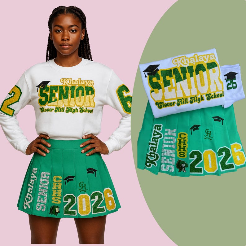 May include: A white sweatshirt and green pleated skirt with gold and green text that reads "Khalaya SENIOR Glover Hill High School 2026". The number "26" is on the socks and the sleeve of the sweatshirt. The outfit is for a high school senior.