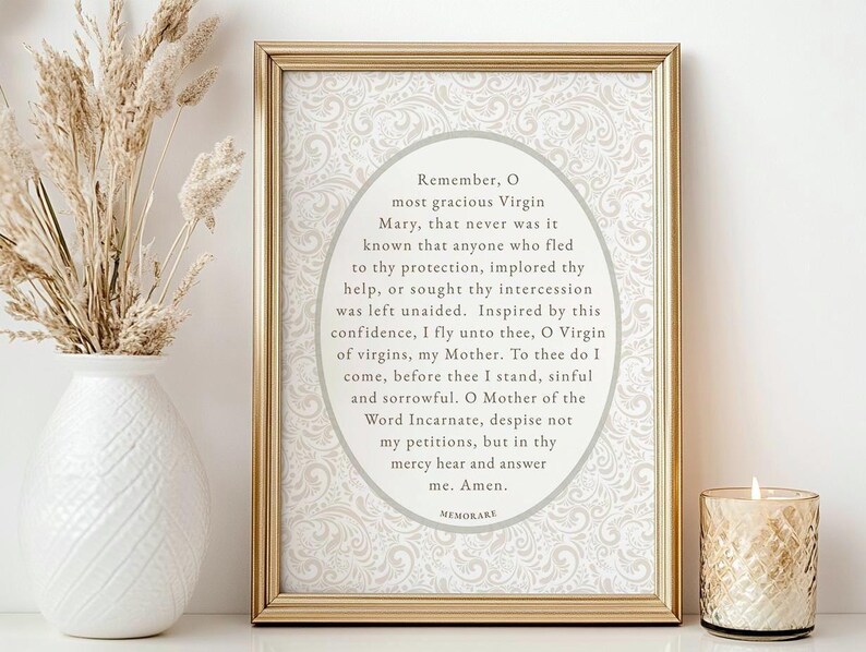 Elegant framed Memorare Prayer printable wall art displayed on a neutral table with a white vase of dried florals and a lit candle — Catholic digital download print in vintage cream tones, perfect for prayer corner or home altar decor.